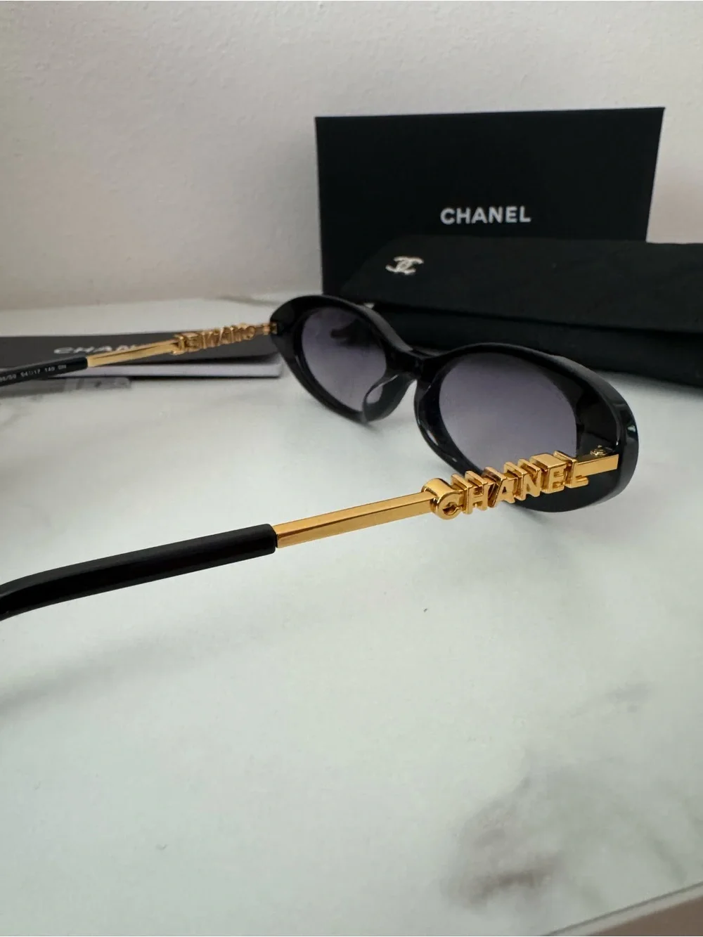 CHANEL Black Oval Sunglasses with Gray Gradient Lenses